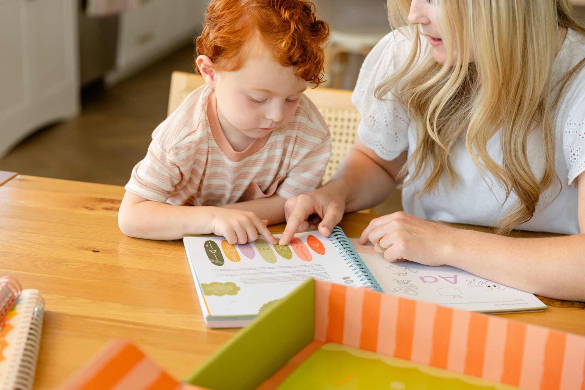 A parent guiding their child through a lesson