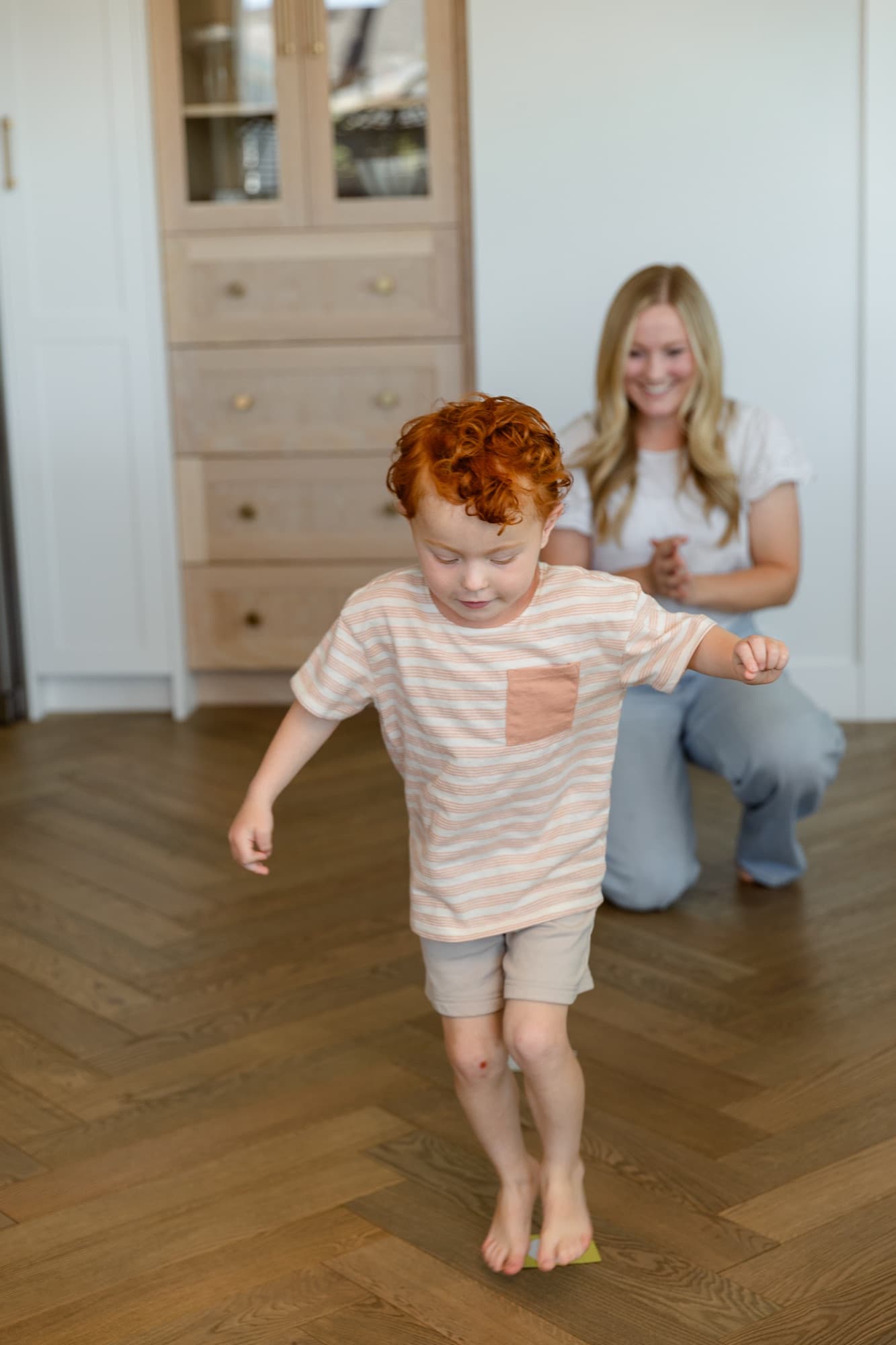 A child hopping between letter cards during a movement game