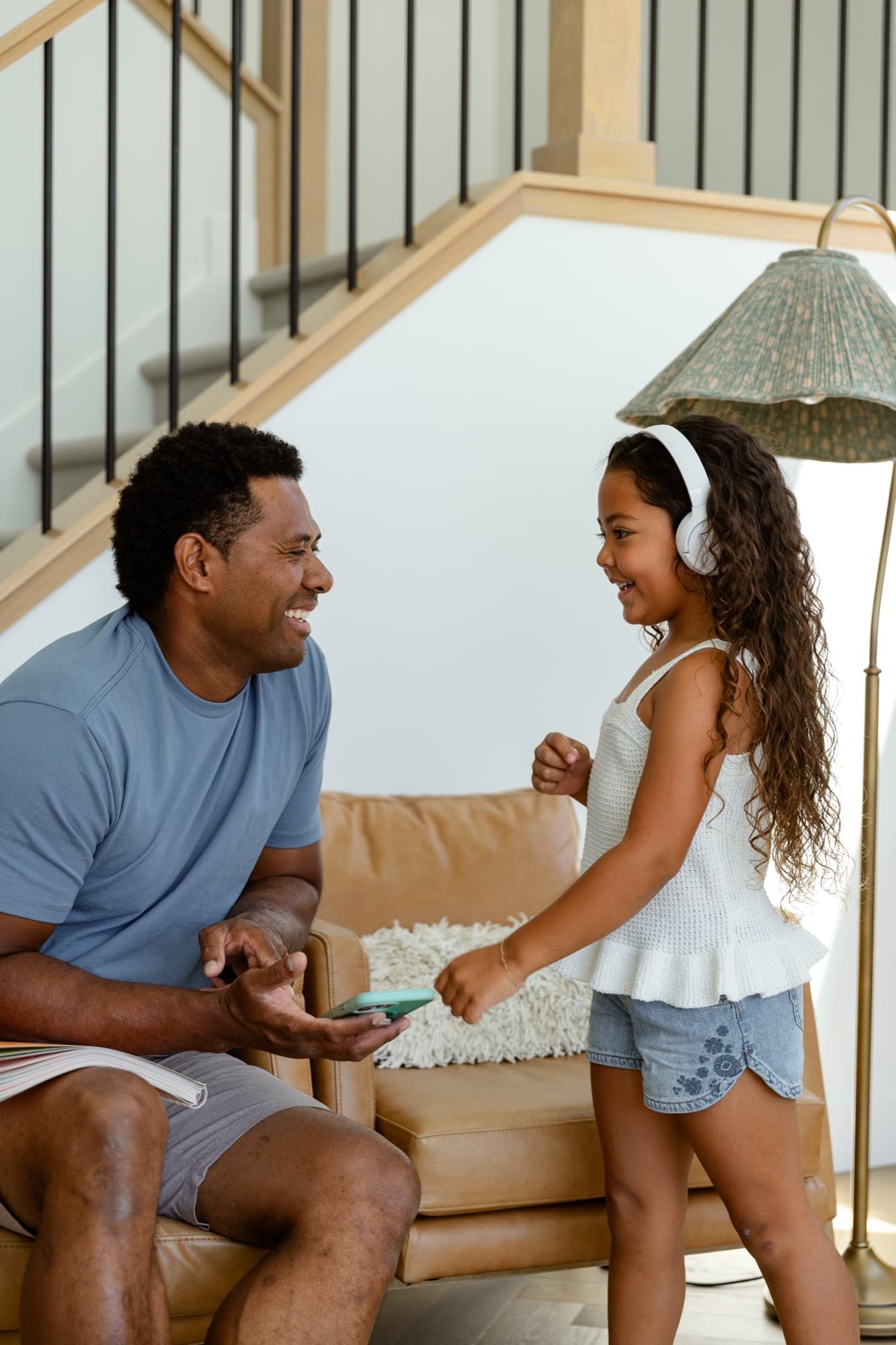 A dad and daughter enjoying songs from the music app